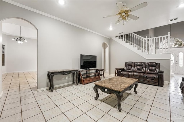 living room featuring light tile patterned flooring, ceiling fan with notable chandelier, and crown molding