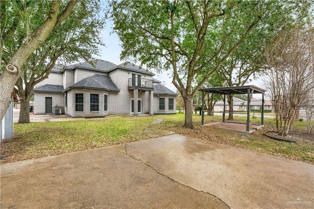 view of front of home featuring a gazebo, a balcony, and a front lawn