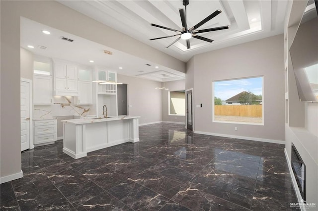 9510 N 71st Ln, Mcallen, TX 78573 - kitchen featuring open floor plan, light countertops, glass insert cabinets, white cabinets, and recessed lighting