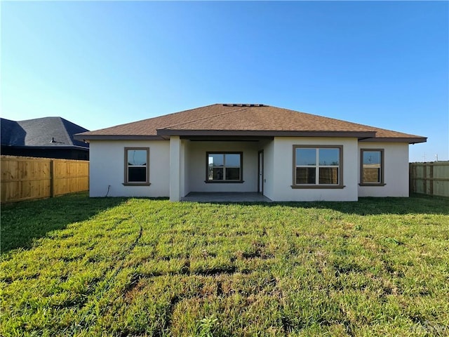 back of property featuring a yard and a patio area