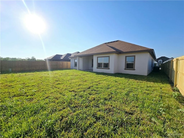 back of house with a lawn