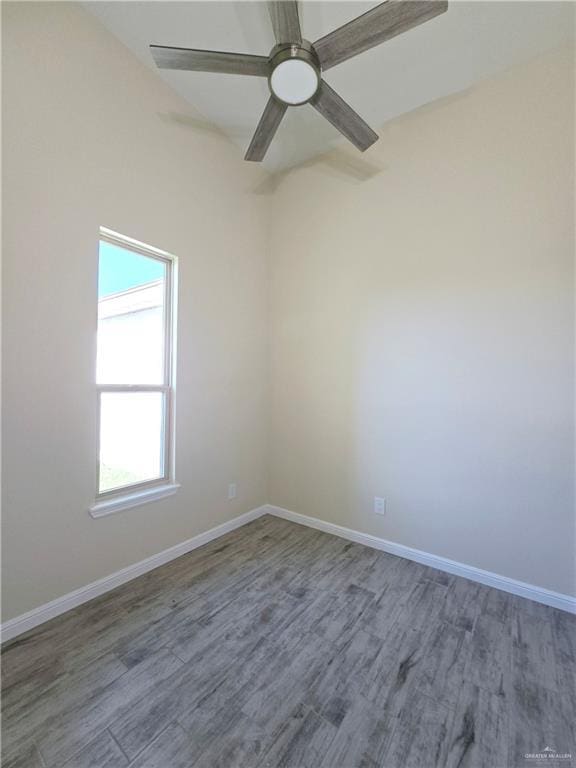 empty room with ceiling fan and hardwood / wood-style floors