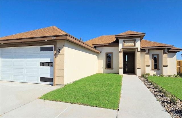 view of front facade with a garage and a front lawn