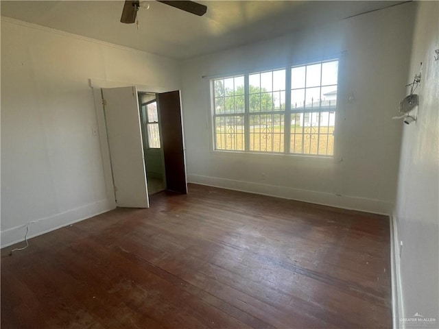 unfurnished bedroom featuring ceiling fan and dark wood-type flooring