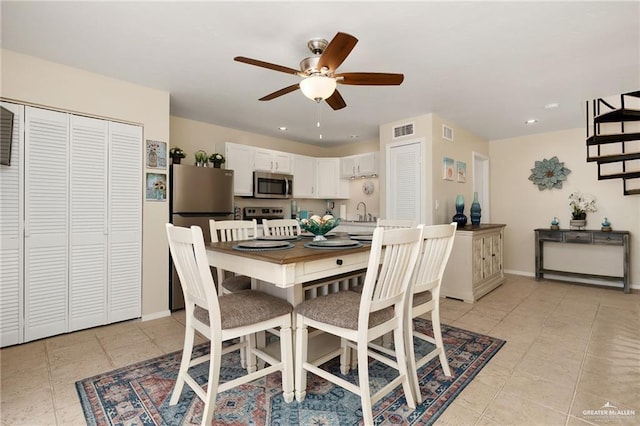 123 Windward Dr, Port Isabel, TX 78578 - dining space featuring a ceiling fan, stairway, recessed lighting, and light tile patterned floors