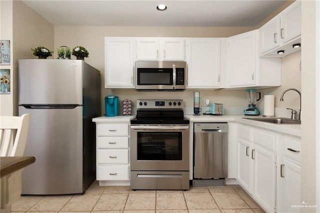 123 Windward Dr, Port Isabel, TX 78578 - kitchen featuring appliances with stainless steel finishes, light countertops, white cabinetry, and recessed lighting