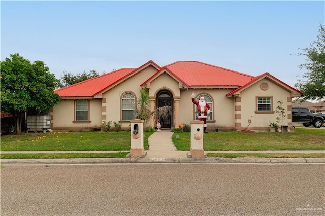 mediterranean / spanish-style house with a front yard