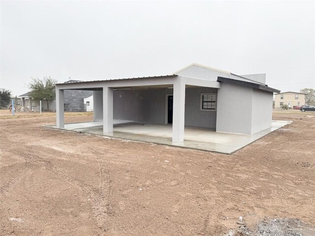 rear view of property with a carport