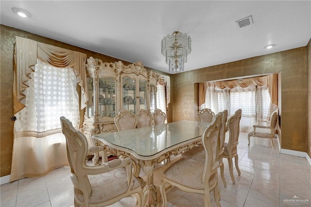 613 E Moore Rd, San Juan, TX 78589 - dining area featuring light tile patterned floors, a chandelier, and baseboards