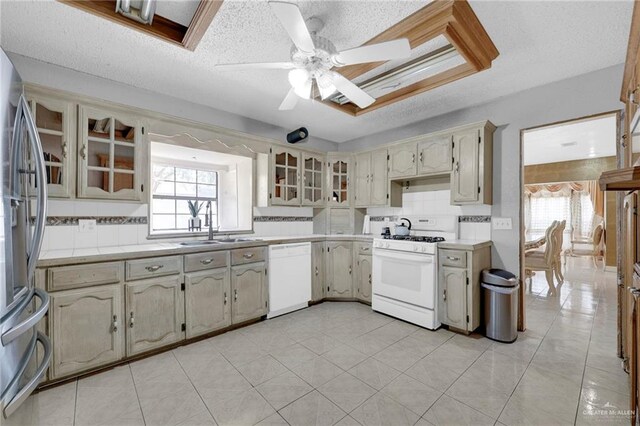 613 E Moore Rd, San Juan, TX 78589 - kitchen with white appliances, light countertops, a ceiling fan, a textured ceiling, and a sink