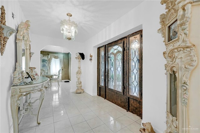 613 E Moore Rd, San Juan, TX 78589 - entrance foyer featuring arched walkways, light tile patterned floors, and a chandelier