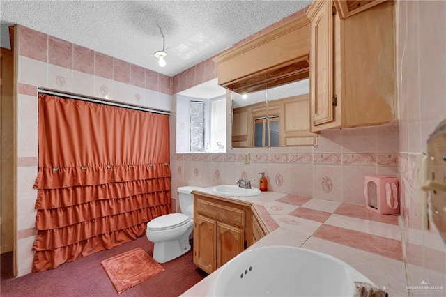 613 E Moore Rd, San Juan, TX 78589 - full bathroom featuring a textured ceiling, double vanity, toilet, a tub to relax in, and a shower
