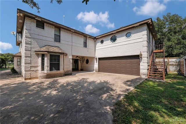 613 E Moore Rd, San Juan, TX 78589 - view of front of house featuring concrete driveway, an attached garage, and stairway