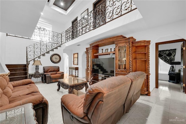 613 E Moore Rd, San Juan, TX 78589 - living room with a high ceiling, stairway, and light tile patterned floors