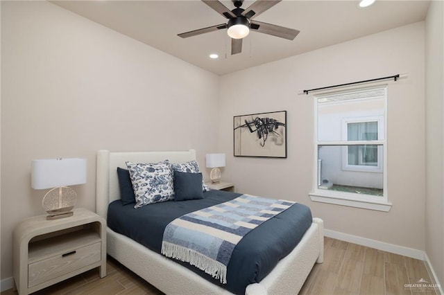 bedroom with ceiling fan and light hardwood / wood-style floors