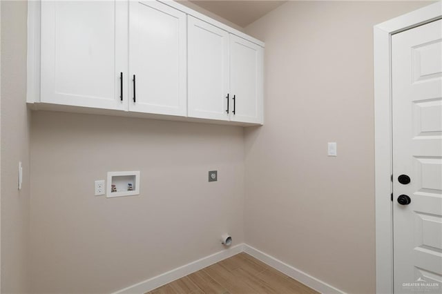 laundry room with cabinets, hookup for a washing machine, light hardwood / wood-style floors, and electric dryer hookup