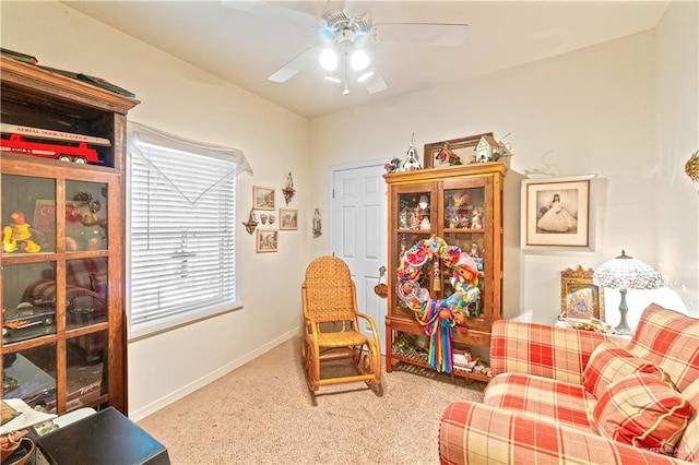 sitting room with carpet flooring and ceiling fan