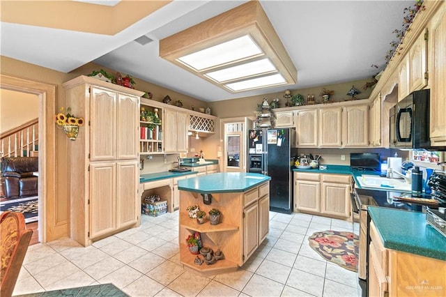 kitchen featuring light brown cabinetry, a center island, light tile patterned floors, and black appliances