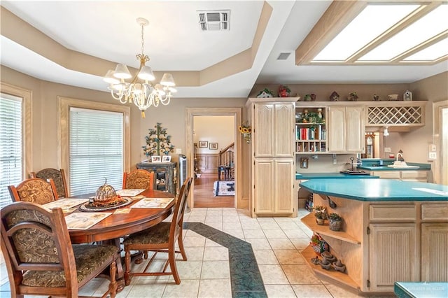 dining space with light tile patterned floors and a notable chandelier