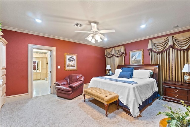 bedroom with ceiling fan, light colored carpet, ornamental molding, and connected bathroom