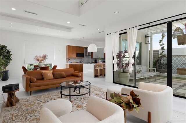 living area featuring recessed lighting and visible vents