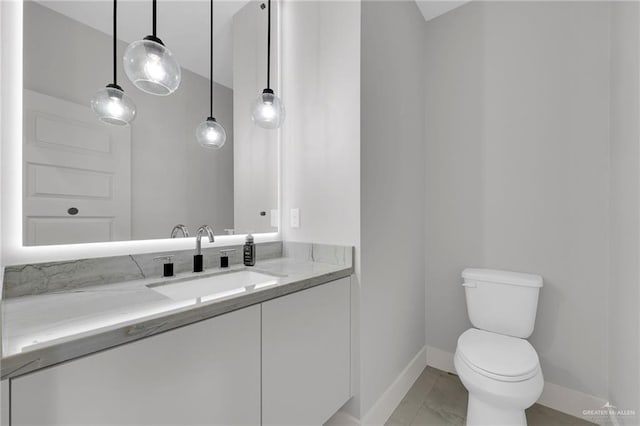 3005 N Alyna Ave, Edinburg, TX 78541 - bathroom with baseboards, toilet, and vanity