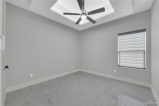3005 N Alyna Ave, Edinburg, TX 78541 - unfurnished room featuring a tray ceiling, light marble finish floors, baseboards, and a ceiling fan