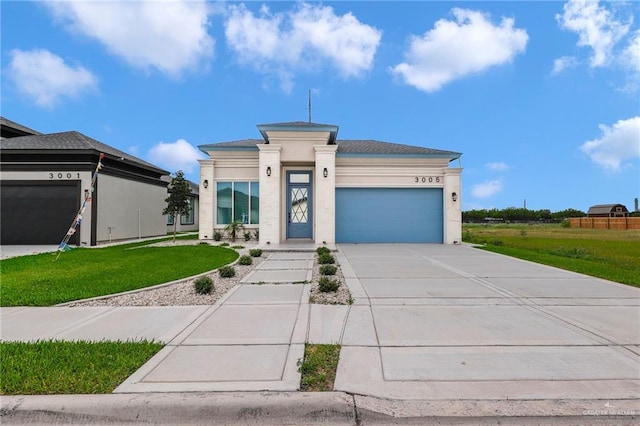3005 N Alyna Ave, Edinburg, TX 78541 - prairie-style home with a garage, a front lawn, driveway, and stucco siding