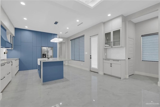3005 N Alyna Ave, Edinburg, TX 78541 - kitchen with modern cabinets, light marble finish floors, light countertops, recessed lighting, and stainless steel fridge