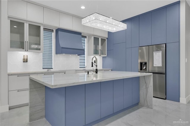 3005 N Alyna Ave, Edinburg, TX 78541 - kitchen featuring stainless steel fridge with ice dispenser, a sink, light marble finish floors, light stone counters, and glass insert cabinets
