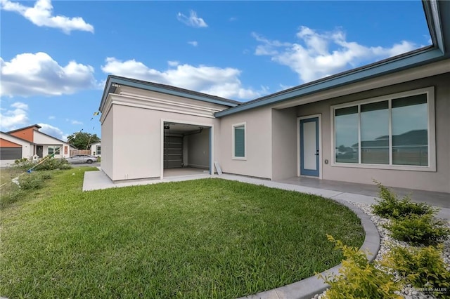 3005 N Alyna Ave, Edinburg, TX 78541 - back of house with stucco siding, a yard, and a garage