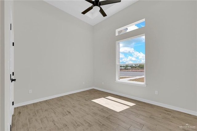 spare room with a ceiling fan, baseboards, and wood finished floors