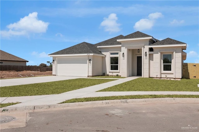 prairie-style home featuring a front yard, an attached garage, fence, and driveway