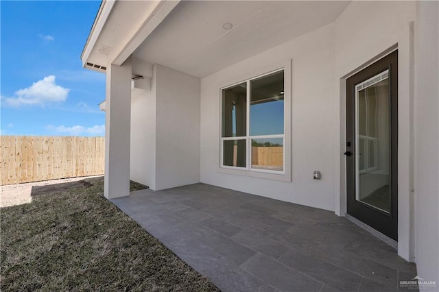 view of patio featuring fence