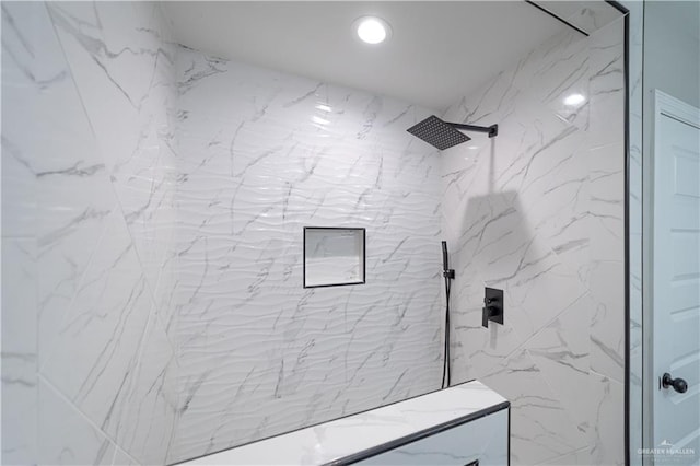 full bathroom featuring a marble finish shower
