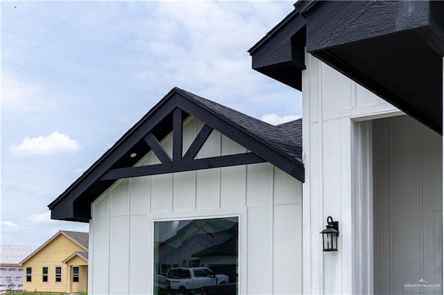 view of property exterior with roof with shingles and a garage
