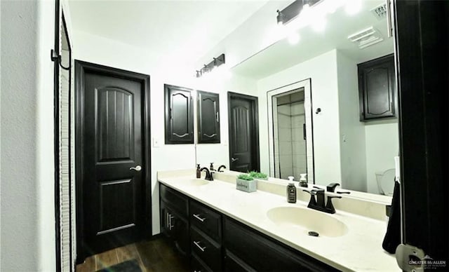 bathroom with hardwood / wood-style floors and vanity