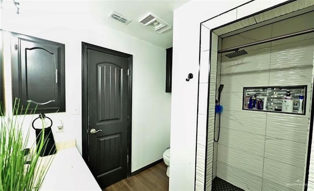 bathroom featuring walk in shower, toilet, vanity, and hardwood / wood-style flooring