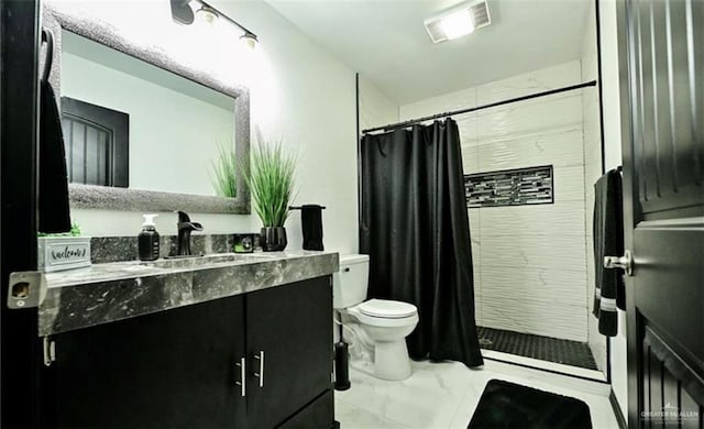 bathroom with toilet, vanity, and walk in shower