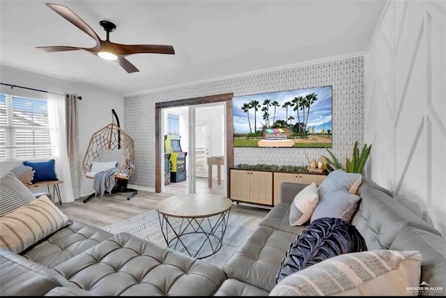 living room with ceiling fan, light hardwood / wood-style floors, and ornamental molding