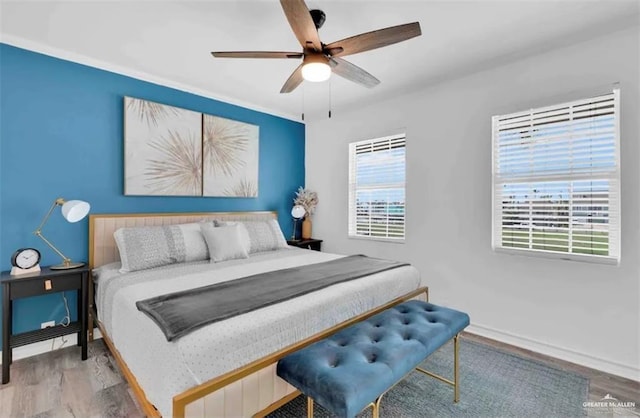 bedroom with ceiling fan and wood-type flooring