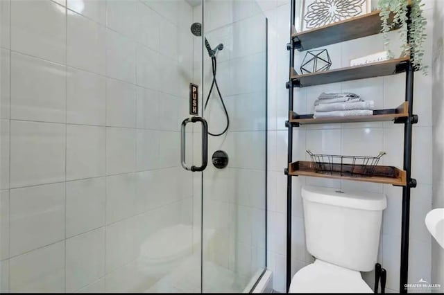 bathroom featuring toilet and walk in shower