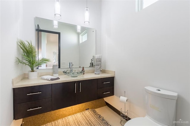 bathroom featuring tile patterned flooring, vanity, and toilet