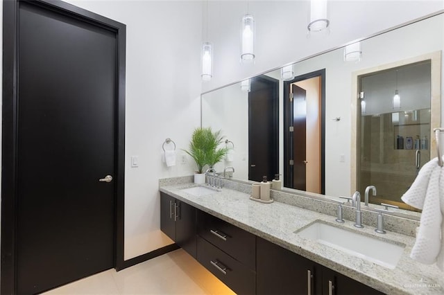 bathroom with tile patterned floors, vanity, and an enclosed shower