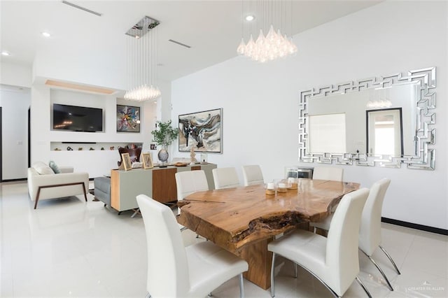 dining area with a notable chandelier and light tile patterned floors