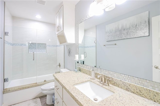 full bathroom featuring vanity, backsplash, toilet, and enclosed tub / shower combo