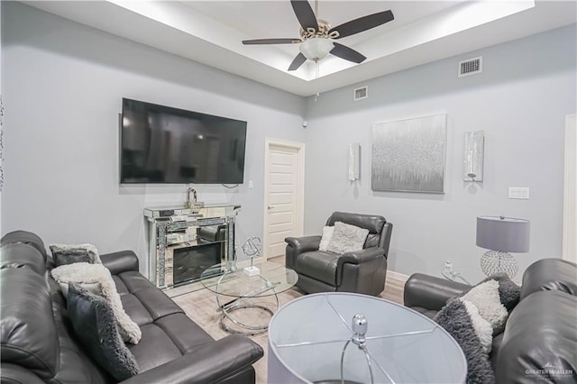 living room with ceiling fan and wood-type flooring