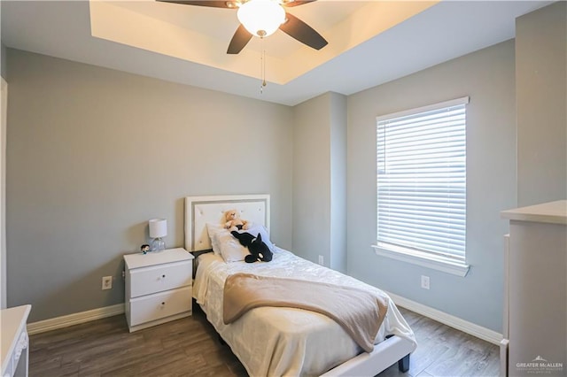 bedroom with ceiling fan and dark hardwood / wood-style floors