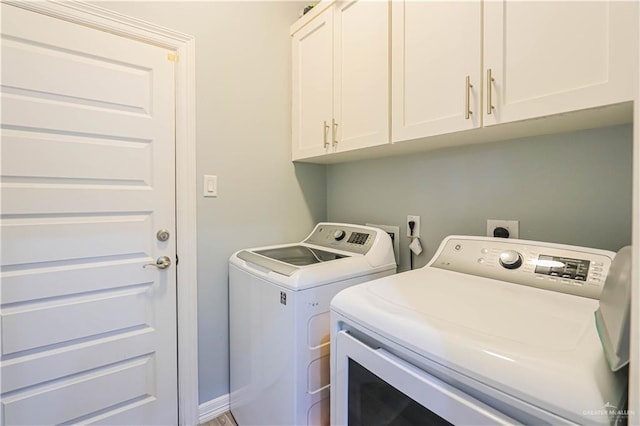 laundry room with cabinets and separate washer and dryer