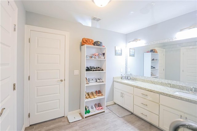 bathroom featuring vanity and hardwood / wood-style flooring